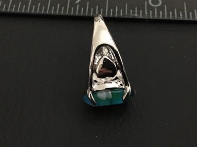 Sale Photo Thumbnail #167: Silver-tone metal statement ring featuring an oval millefiori art glass cabochon in shades of blue, green, white, and red with floral cane details. The band features openwork accents on the sides. Ring is approximately size 7 based on the ring mandrel pho