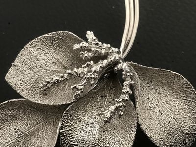 Sale Photo Thumbnail #23: Vintage silver-tone Giovanni brooch featuring an intricate botanical leaf spray design with textured vein details and delicate berry accents. Measures approximately 3 inches in length. Features a secure rollover safety clasp on the back. Stamped with the 