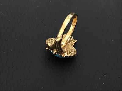 Sale Photo Thumbnail #258: Vintage gold tone statement ring featuring a large oval faux turquoise cabochon with a twisted rope textured border and ornate setting. Measures approximately size 6 on ring mandrel. Good vintage condition with light finish wear visible on the band.