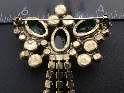 Sale Photo Thumbnail #4: Vintage statement brooch featuring emerald green art glass cabochons with white/swirled inclusions, multi-tone green and light yellow rhinestones, and hanging rhinestones with dangle cabochons. Set in a gold-tone or brass-tone metal mounting with a rollov
