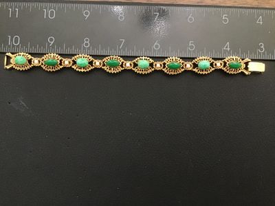 Sale Photo Thumbnail #9: A vintage signed Florenza gold-tone link bracelet featuring alternating oval and marquise-cut faux green jade cabochons, accented with small faux pearls between filigree-style ornate metal links. Measures approximately 7.25 inches in length. Marked 'FLORE