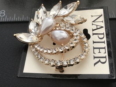Sale Photo Thumbnail #35: Napier gold-tone brooch featuring marquise-cut clear rhinestones, a pave rhinestone circle detail, and two teardrop-shaped faux pearls. New on original store display card (MSRP $24.00). Pin closure on back in excellent condition. Measures approximately 2 