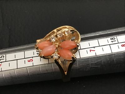 Sale Photo Thumbnail #187: Gold-tone fashion statement ring featuring four marquise-cut coral-pink stones arranged in a floral design, accented with clear round rhinestones. Ring size measures approximately 6 on a ring mandrel. Good condition with light overall wear.