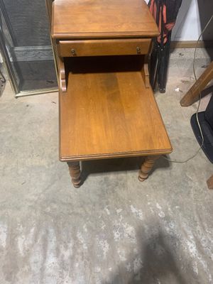 Sale Photo Thumbnail #15: Mid-century wooden two-tier step-end table featuring a top drawer with small metal knobs and turned front legs.