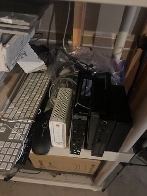 Sale Photo Thumbnail #28: Collection of computer electronics, including an Apple keyboard, a Motorola modem, mini PCs, and assorted cables.