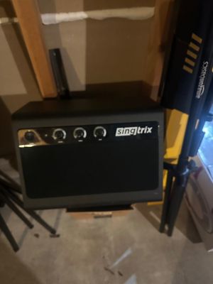 Sale Photo Thumbnail #29: Singtrix karaoke system speaker with front control knobs, shown next to an AmazonBasics tripod stand.