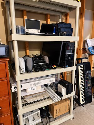 Sale Photo Thumbnail #4: Off-white plastic four-tier shelving unit filled with vintage electronics, including portable DVD players, a Dell desktop computer tower, speakers, and computer peripherals.