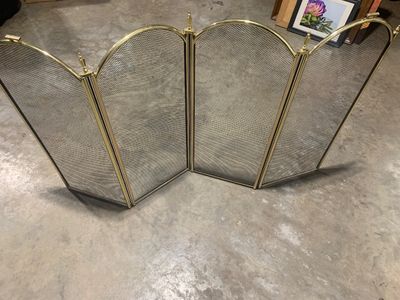 Sale Photo Thumbnail #16: Four-panel folding brass fireplace spark screen with arched tops, finial accents, and wire mesh.