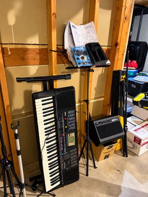 Sale Photo Thumbnail #3: Yamaha portable electronic keyboard setup alongside music stands, a Singtrix speaker amplifier, and various musical equipment accessories.