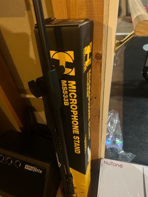 Sale Photo Thumbnail #20: Hercules MS533B microphone stand in its original box, shown with an assembled stand nearby.