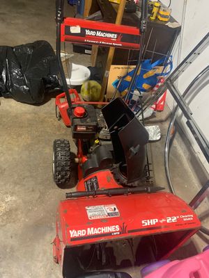 Sale Photo Thumbnail #18: Yard Machines by MTD two-stage snow blower featuring a 5 HP Tecumseh engine and 22-inch clearing width, showing light surface rust and wear consistent with use.