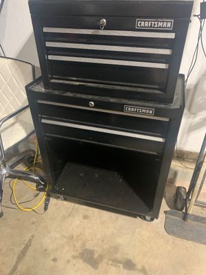 Sale Photo Thumbnail #12: Black metal Craftsman two-piece rolling tool chest combo, featuring a multi-drawer top box stacked on a rolling cabinet base with drawers and lower open storage.