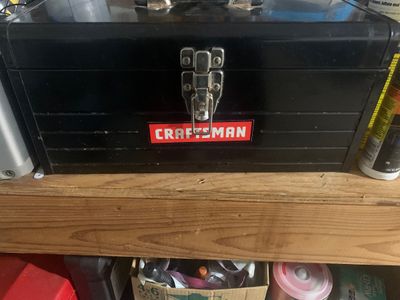 Sale Photo Thumbnail #11: Black metal Craftsman toolbox featuring a silver latch mechanism and the red Craftsman logo on the front.