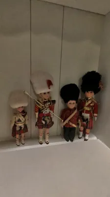 Set of four vintage souvenir dolls dressed in traditional Scottish Highland and Royal Guard parade attire, featuring bear fur style hats...