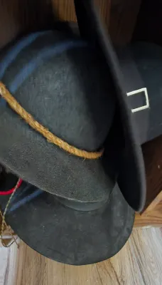 Sale Photo Thumbnail #20: Collection of vintage black felt wide-brim hats, including one with a braided rope band and another with a silver-tone rectangular buckle.