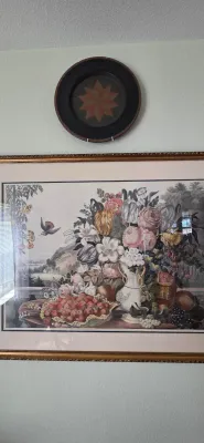 Sale Photo Thumbnail #78: Large framed botanical and floral still life art print under glass, paired with a small circular wall plate featuring a folk art star pattern.