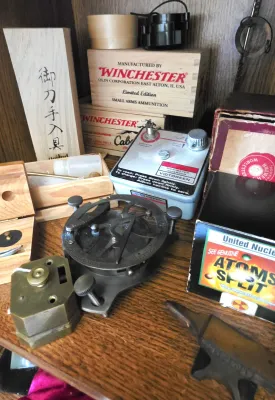 Sale Photo Thumbnail #16: Collection of scientific instruments, collectibles, and wooden boxes, including a Victoreen dosimeter charger, a miniature anvil, and Winchester ammunition boxes.