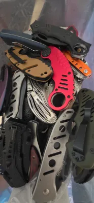 Sale Photo Thumbnail #7: Large collection of modern folding pocket knives and tactical blades in various colors and designs.