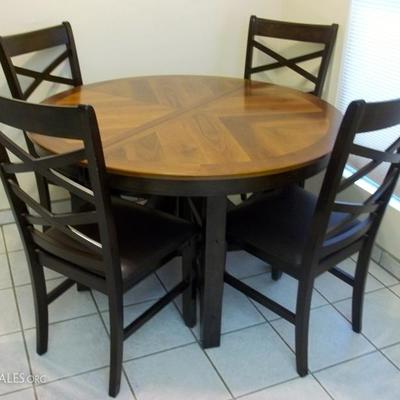 Round table opens up to oval with hidden leaves