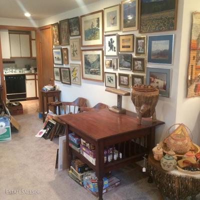Wall of prints, photographs and other original works of art.