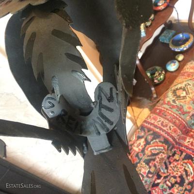 Signature on base of metal raven sculpture