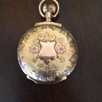 Vintage 14K Gold Pocket Watch.  Hand cut design of flowers, leaves, and birds.  That case is completely hand tooled.  It has white,...