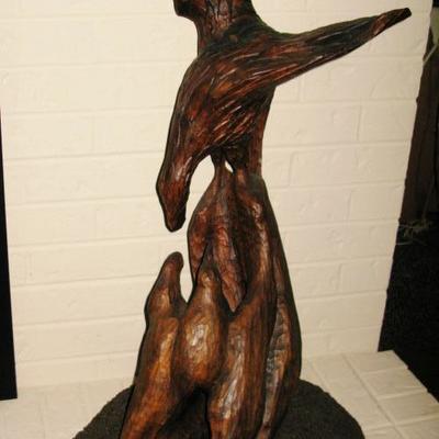 large carved eagle feeding babies in nest 