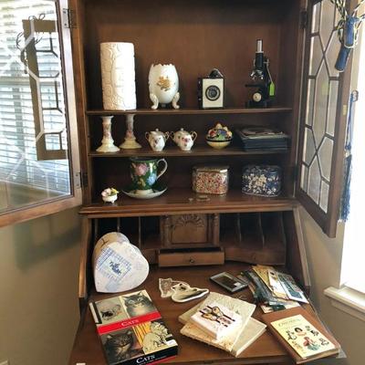 Antique Secretary loaded with decoratives 
Brownie Camera 
Microscope 