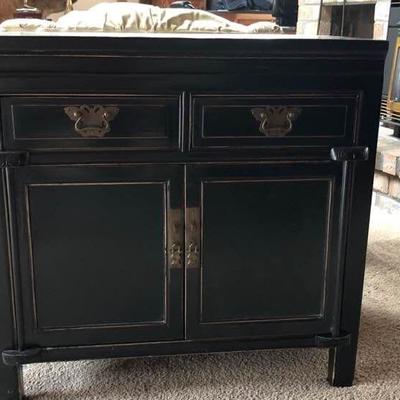 Black cabinet with brass hardware