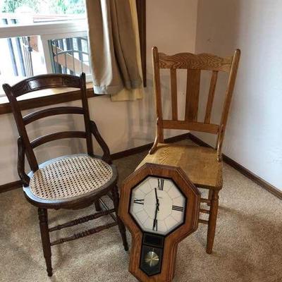 A pair of chairs and a pendulum clock