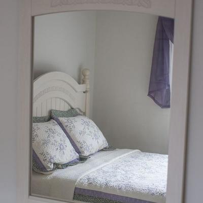 Soft-white (linen), queen three piece bedroom set by Design by Ashley with headboard, bedside table, and dresser with mirror.