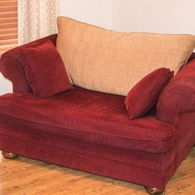 Overstuffed, double chair with contrasting pillows.