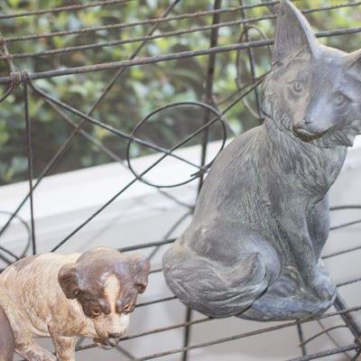 Iron Victorian plantstand and garden animals.