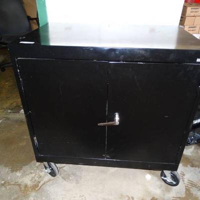 Metal cabinet on wheels.