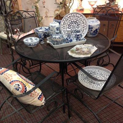 Wrought iron patio set.  Love the spring base to the chairs!