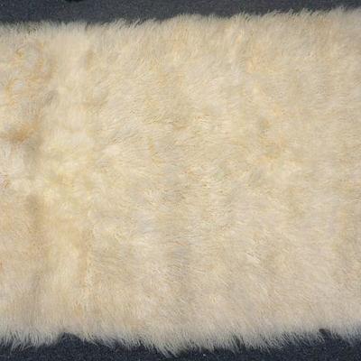 Large Mongolian Lamb Throw / Rug from Fun with Furs in Chicago. Measure 45"x70". Lined in a fawn color velveteen. 