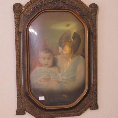 A truly elegant piece. The frame is exquisite with the bubble glass and the lovely woman and child makes this piece irresistible.