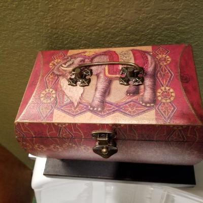 (No. 148) Red and beige wooden elephant storage box attached to base, black lacquered inside. Approx 10" left to right ~ $20
