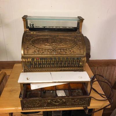 Closer view of old brass cash register 