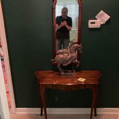 A handsome fellow and a fine console table and mirror.