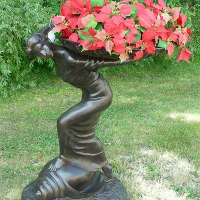 Bronze sculpture of woman with tray