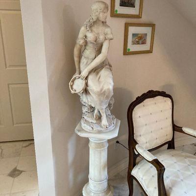 Marble maiden on pedestal. 