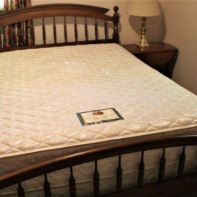 Plush, queen bed set is in excellent condition.  Wooden spindles highlight the head and footboard.