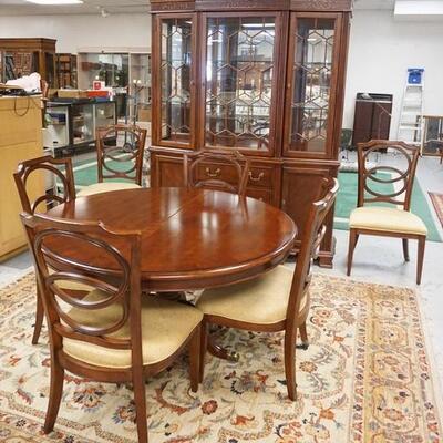 1011	BASSETT DINING ROOM SET, BREAKFRONT, 53 IN ROUND TABLE W/ONE 24 IN LEAVE & A SET OF 6 CHAIRS
