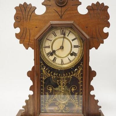 1090	CARVED WALNUT GINGERBREAD CLOCK, HAS PAINTED DOOR & A FRAGMENT OF THE ORIGINAL LABEL ON THE BACK. 14 1/2 IN W 21 1/2 IN H 	100...