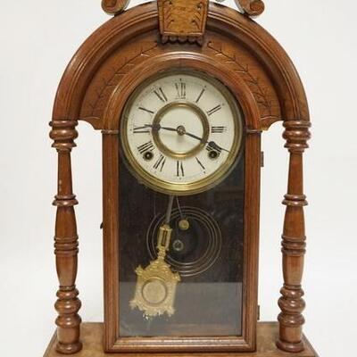 1089	CARVED WALNUT GINGERBREAD CLOCK, HAS FULL TURNED COLUMNS & AN OLD STORE LABEL BARGAIN BARN NEPTUNE. 14 5/8 IN W 22 1/2 IN H 	100...