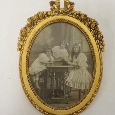 1008	ANTIQUE GILT OVAL FRAME W/PHOTO OF 3 YOUNG GIRLS, 7 1/2 IN X 5 1/2 IN
