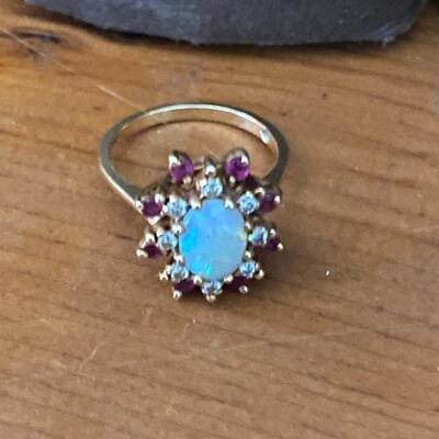 Opal Ring with Diamondâ€™s & Rubyâ€™s, 14 karat yg
yellow gold size 6 1/2 to 7 and 4.6 grm total weight.