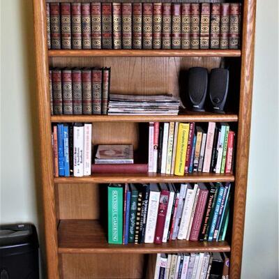 Books, bookcases and even a complete set of Deluxe Funk and Wagnalls dictionaries, copyright 1949.