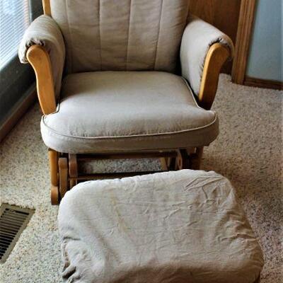 Cushioned glider with matching glider footrest.